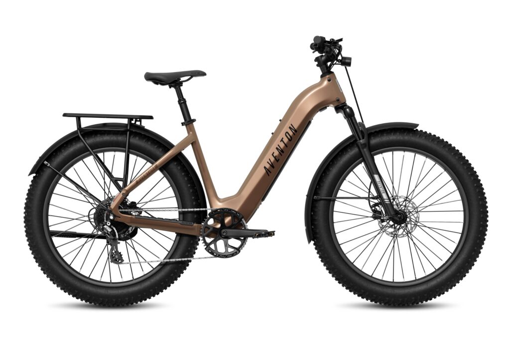 Side view of a bronze-brown Aventon Aventure 3 step-through fat-tire electric bike with a low stepped frame, rear rack, black fenders and 4-inch knobby tires on a white background